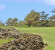 A lava-rock wall lines the 16th fairway at Poipu Bay Golf Course. 